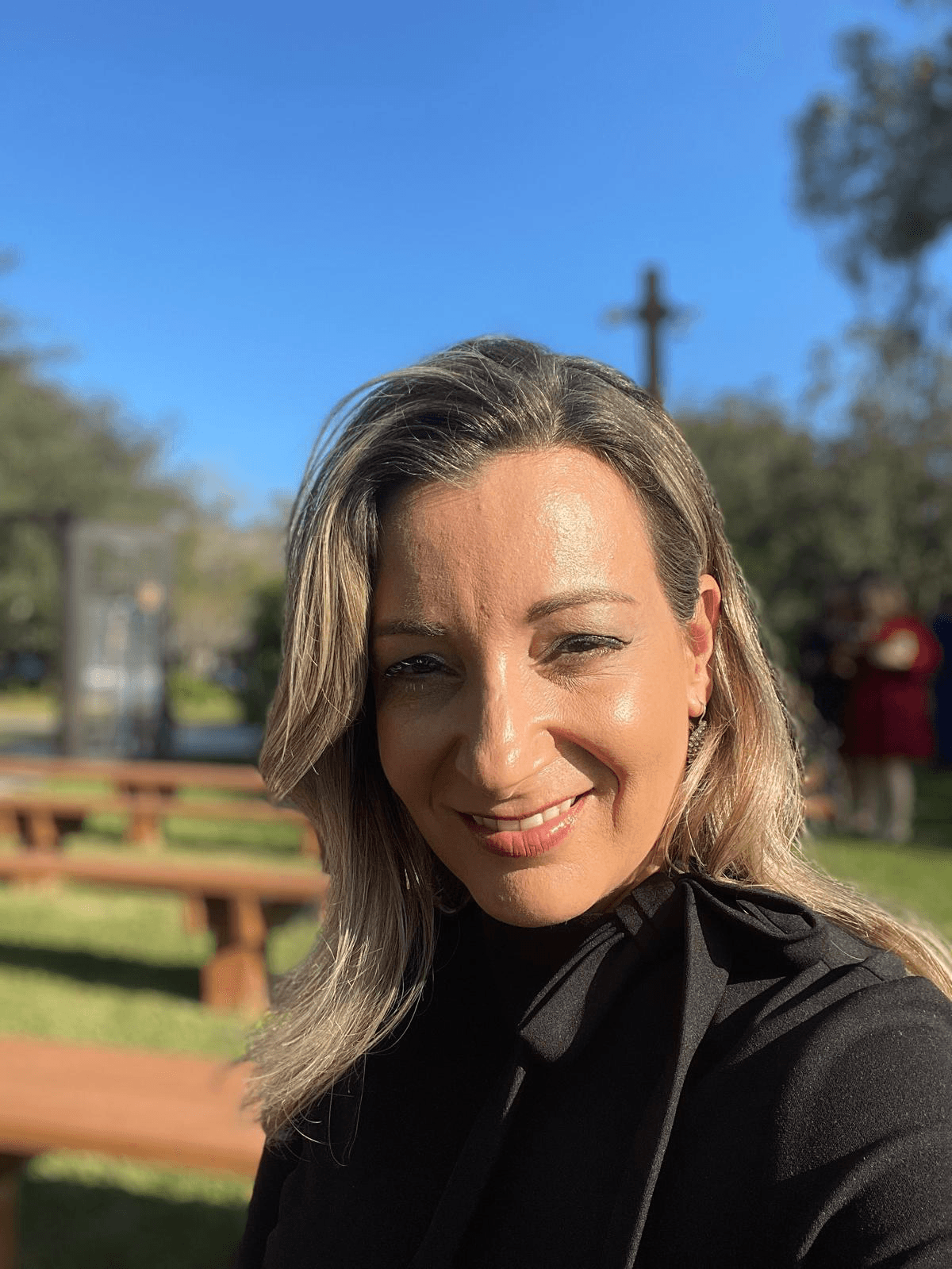 Andressa Nascimento, founder of Divine Delights, smiling outdoors